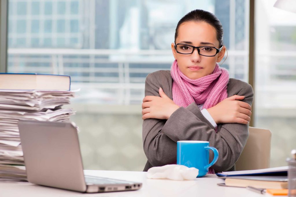 woman cold in an office