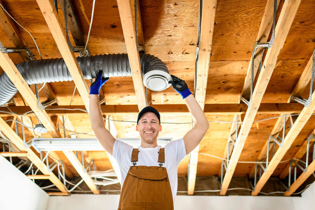 male contractor installing an air conditioning unit