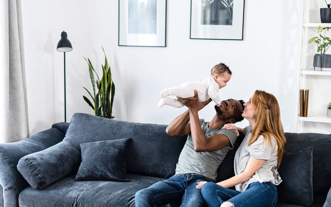 A multiracial family on the comfortable couch at home