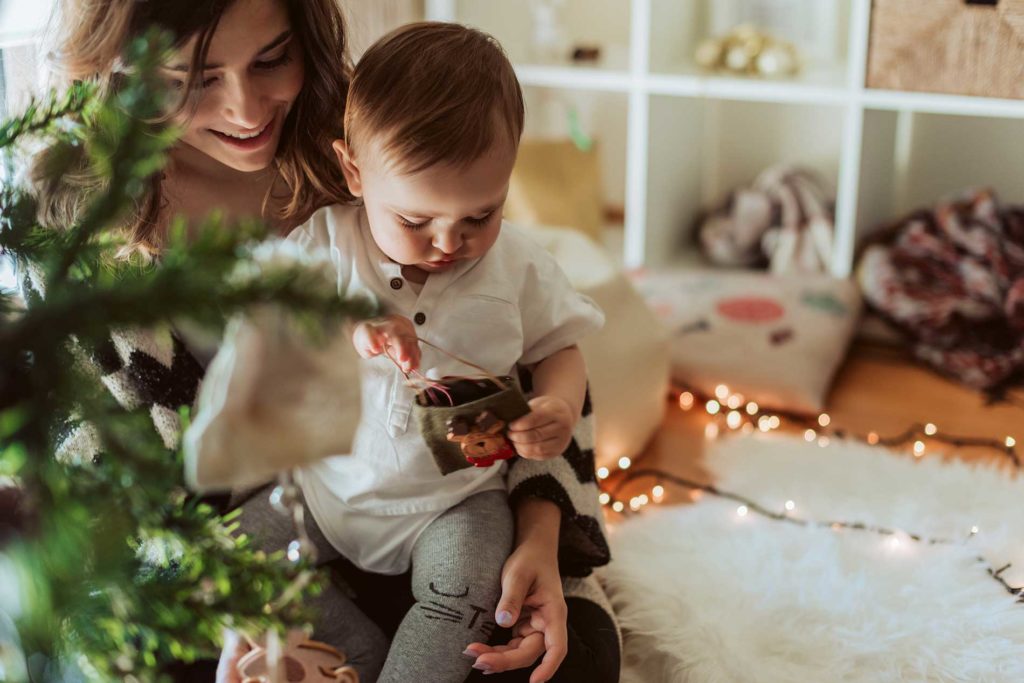 woman and child near a christmas tree