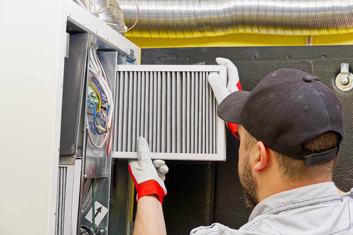 HVAC service technician changing dirty air filter HVAC service technician changing dirty air filter